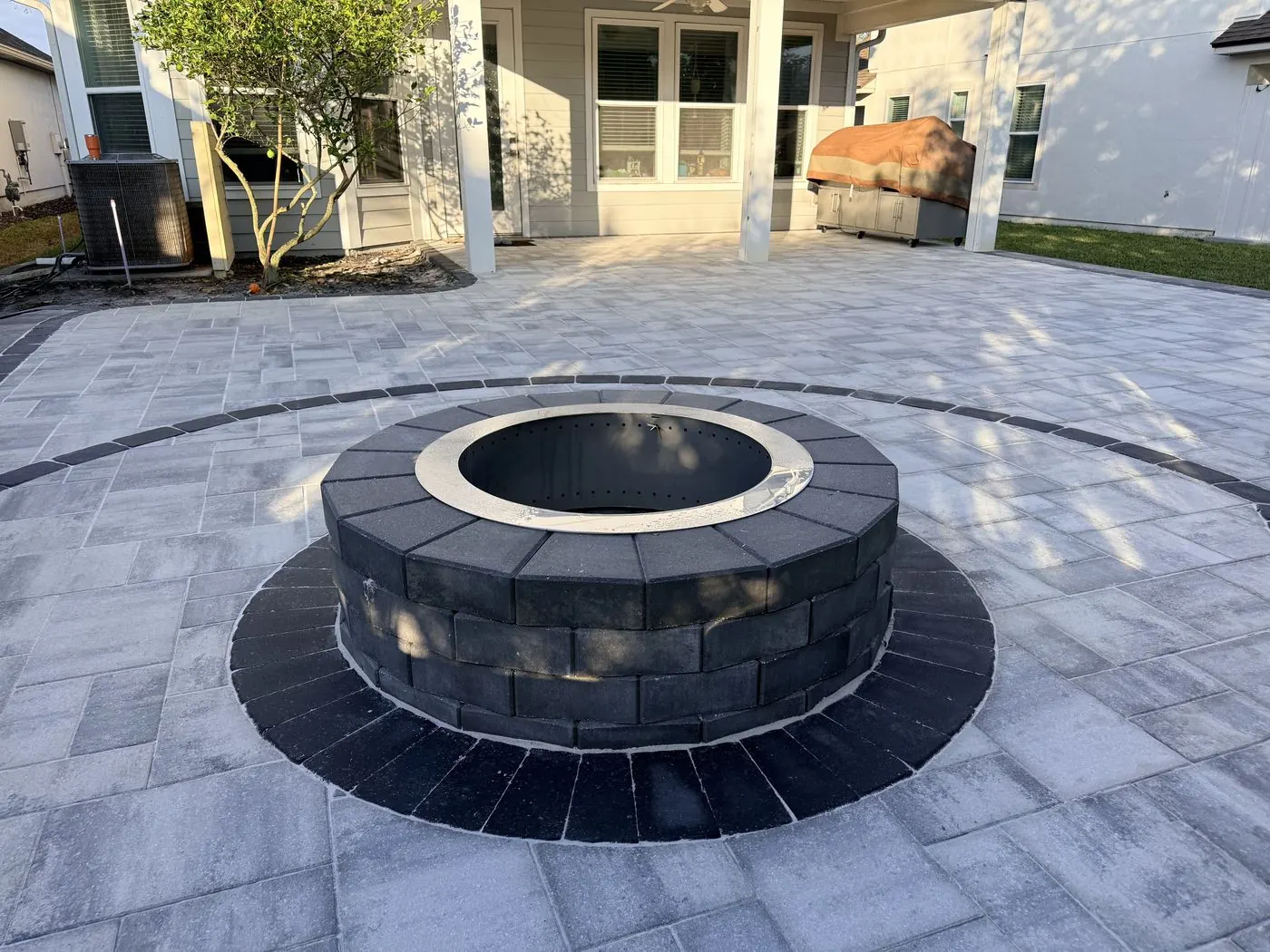 Custom paver firepit set into a wide paver patio, Nocatee FL